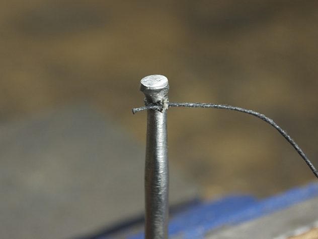 Anchored waxed thread on fencing blade