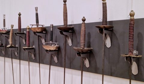 Antique swords on fencing sword wall mounts